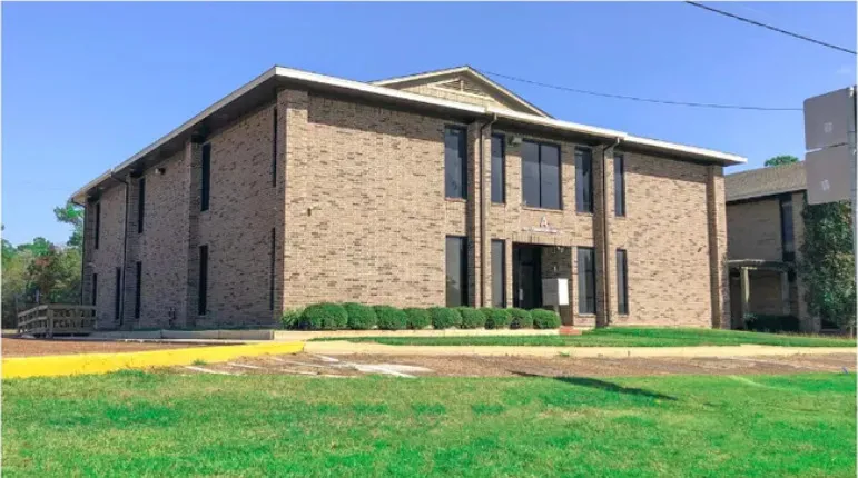 Building A seen from the corner, showing the brick elevation and the walkway to the entrance.