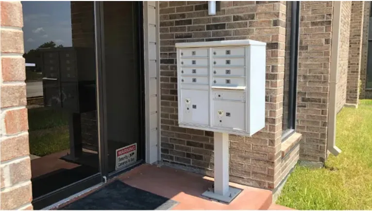 Secure mailbox cluster beside a Building A entrance door.
